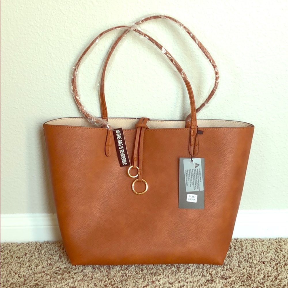 Reversable large tote with inside zipper.